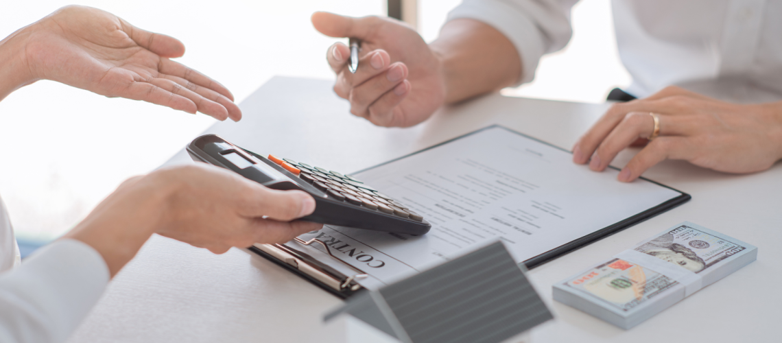 duas pessoas avaliando valores com uma calculadora na mão